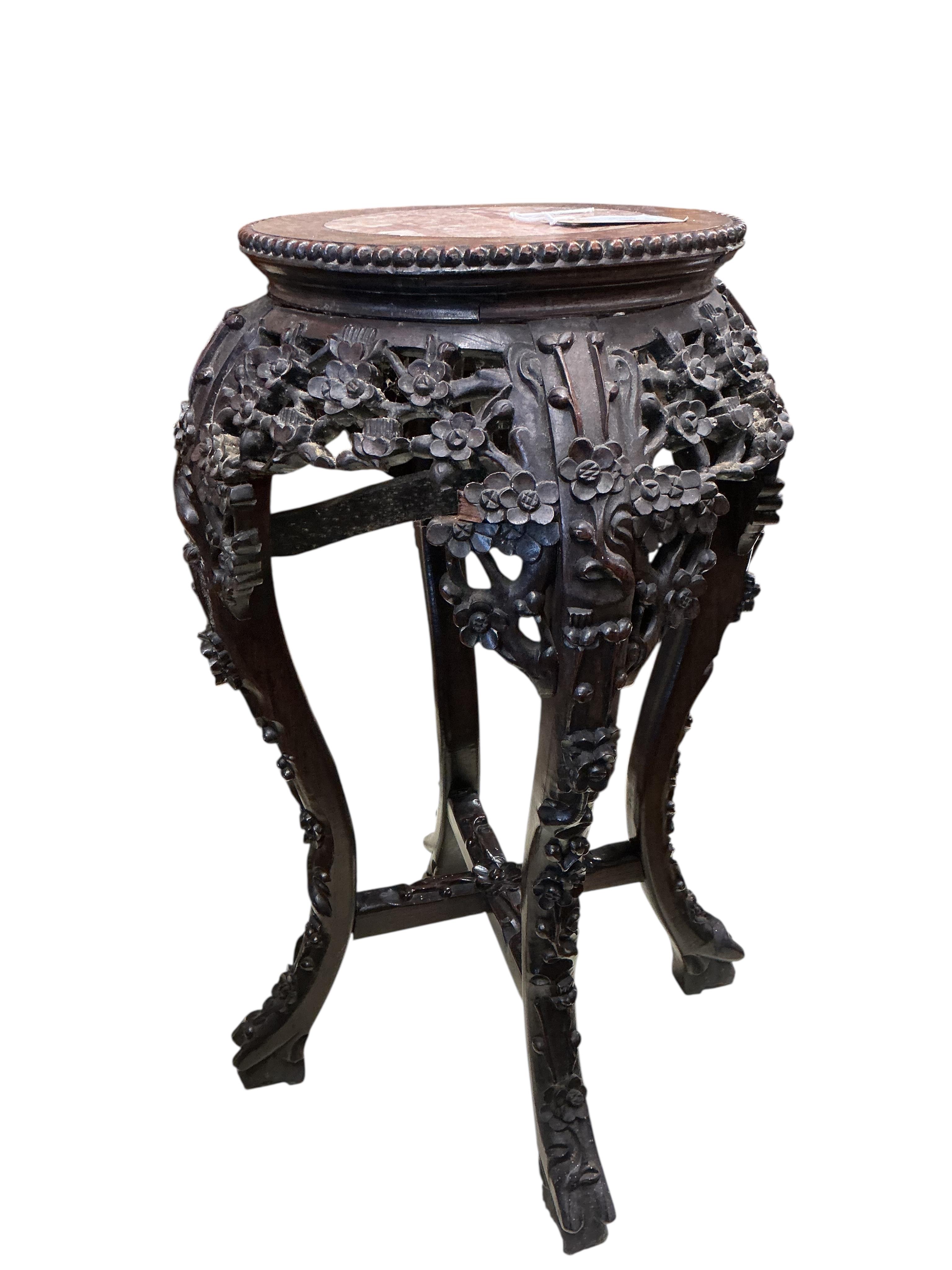 A Chinese carved padouk rouge marble topped jardiniere stand, height 60cm